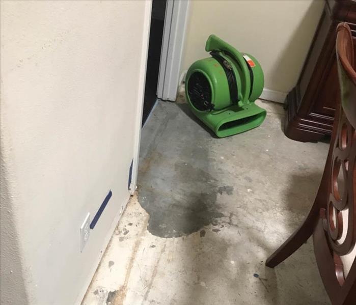 Air mover in corner of room.